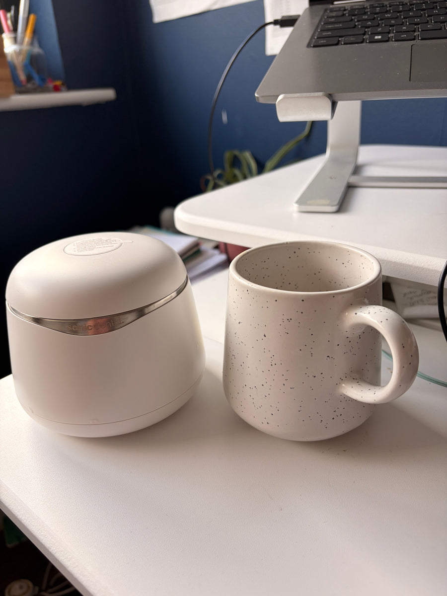 Customer photo of a white Sonic Pro cleaner beside a coffee cup